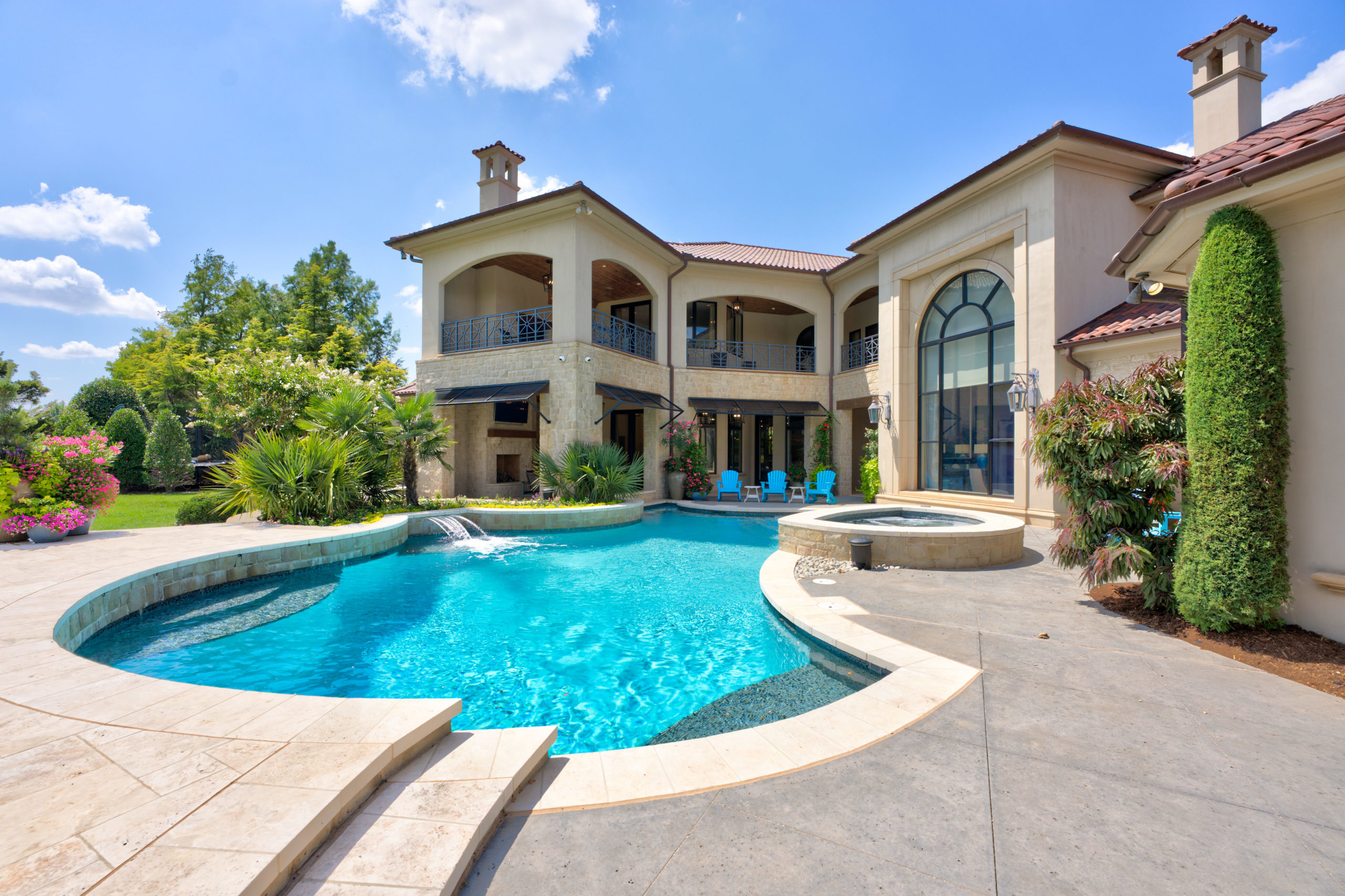 a photo of a luxury house with a pool
