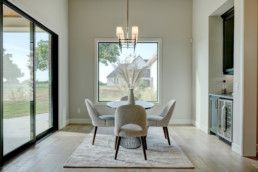 real estate photo of a dining room with a table and chairs
