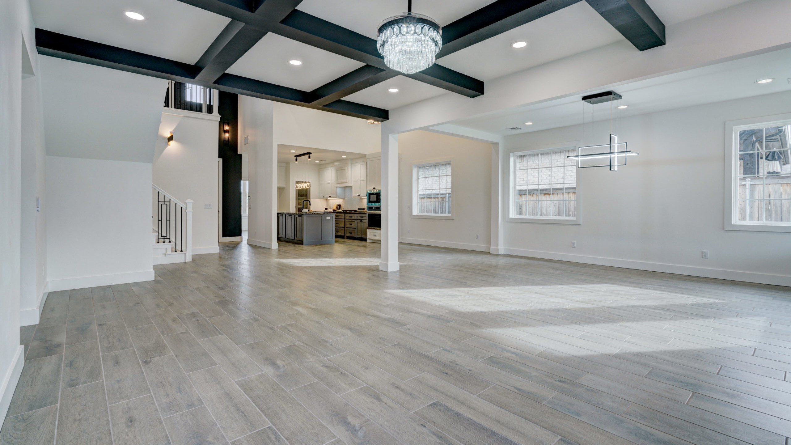 a empty living room with an open concept into the dining room and kitchen