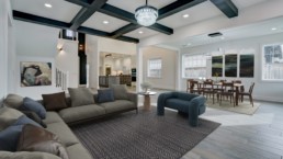 a living room filled with furniture and a dining room table