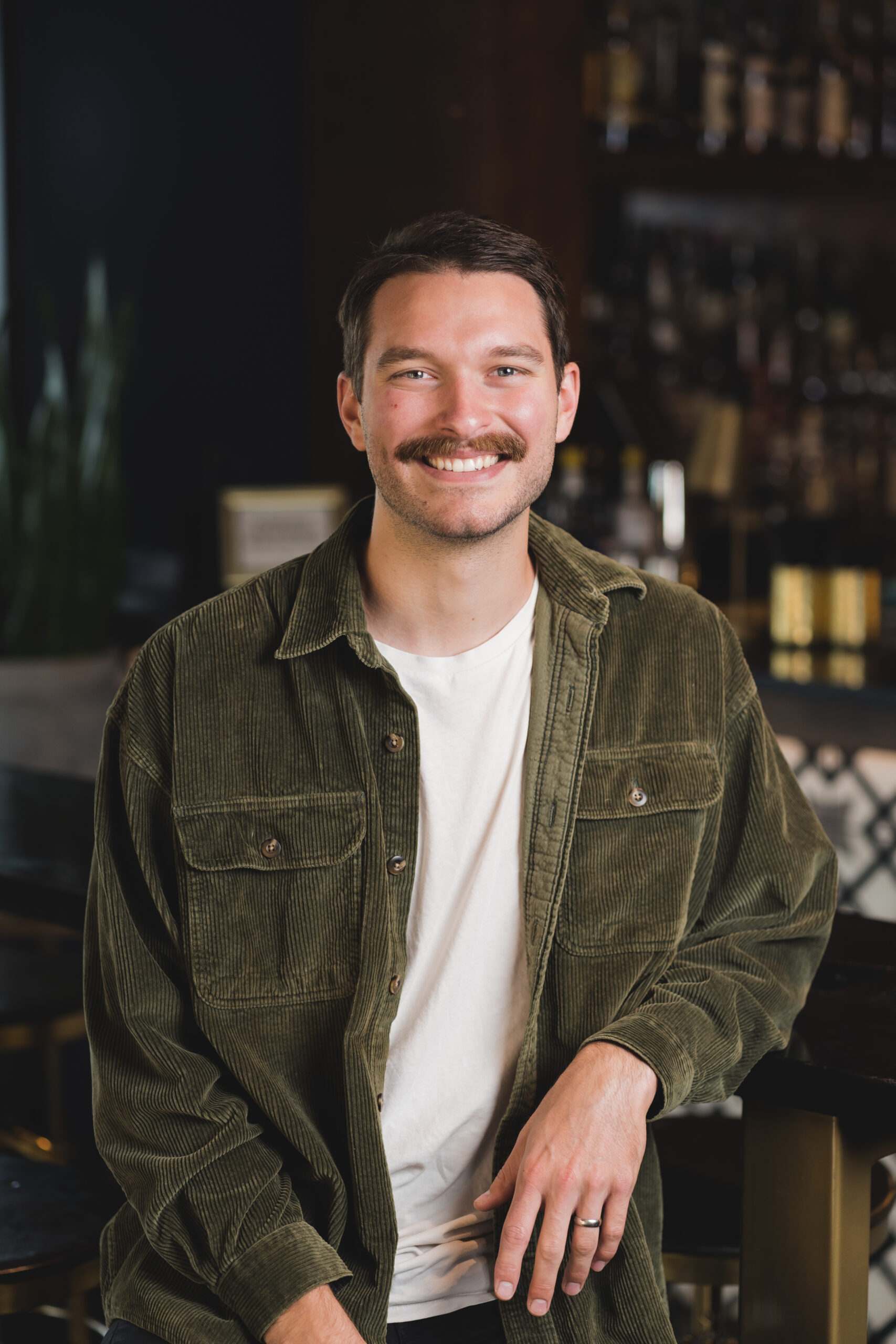 a man with a mustache sitting at a table